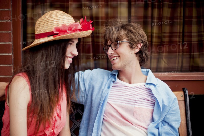 Laughing couple sitting on bench
