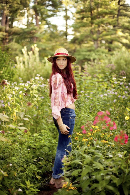 Girl wearing straw hat in garden