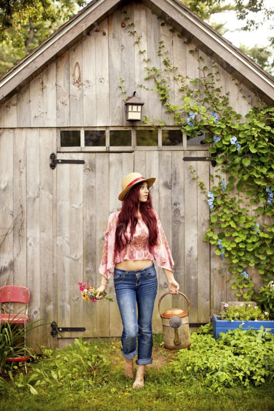 Gardener picking flowers in garden