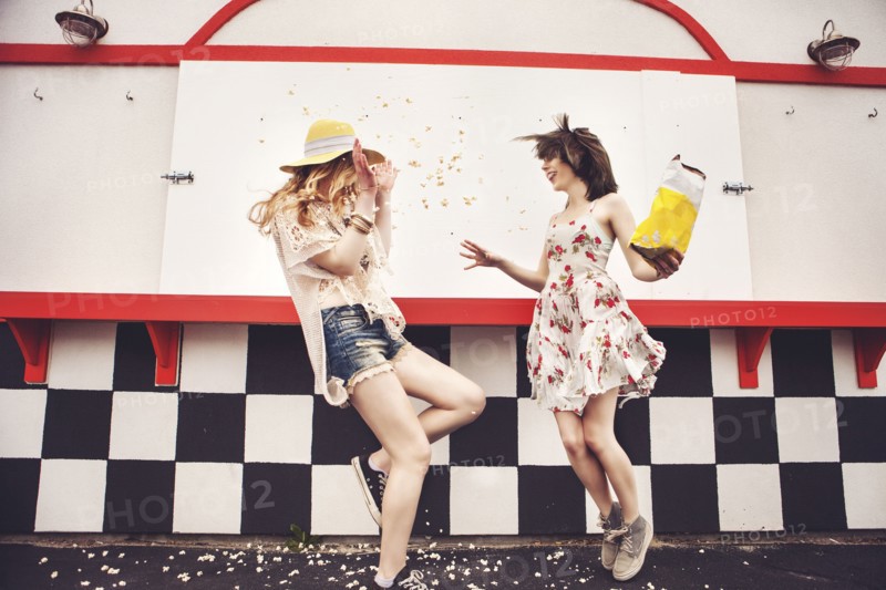 Caucasian friends having popcorn fight outdoors