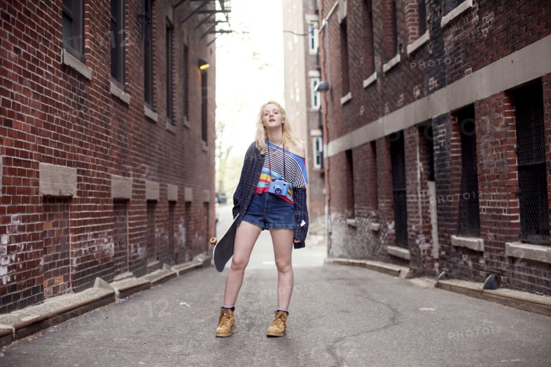 Caucasian woman standing in city alleyway