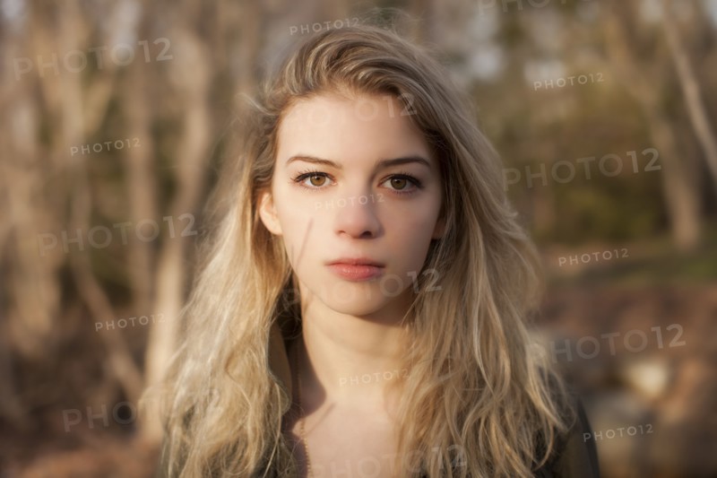 Caucasian teenage girl standing in park