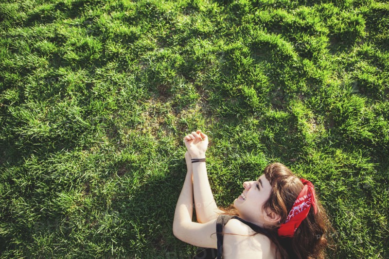 Caucasian woman laying in grass