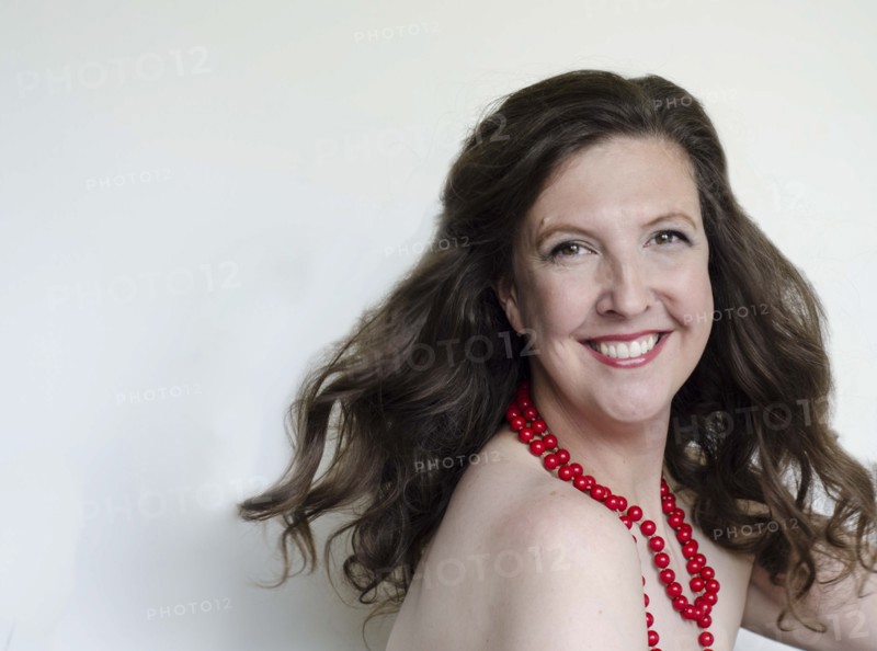 Close up of smiling woman wearing bead necklace