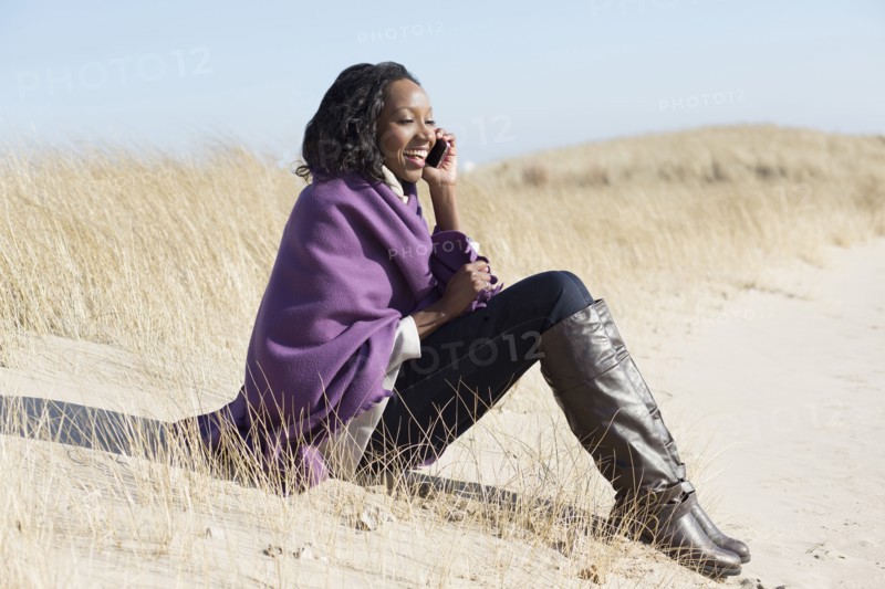 Woman talking on cell phone on beach