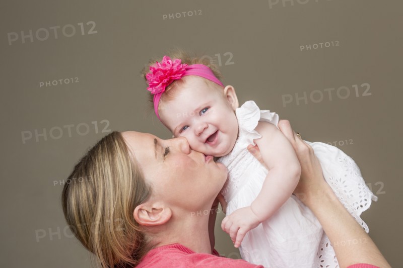 Close up of mother kissing baby girl