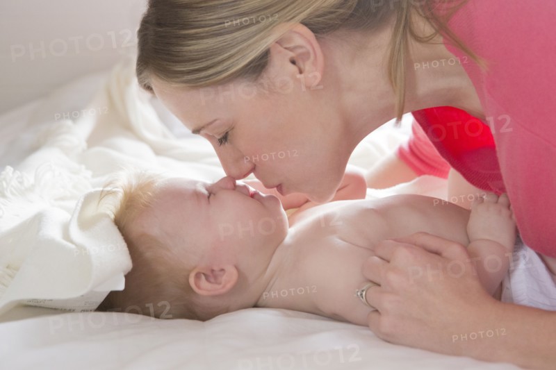 Close up of mother kissing baby girl