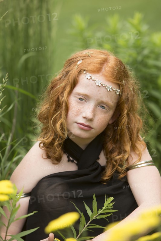 Caucasian girl wearing flower crown in garden