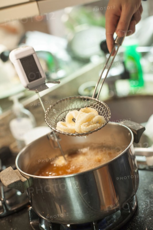 Close up of woman frying onions in kitchen