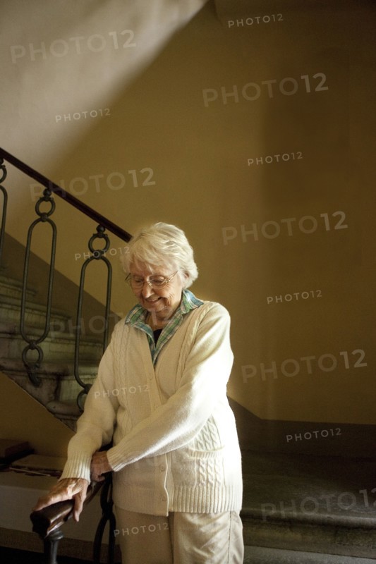 Older Caucasian woman climbing stairs