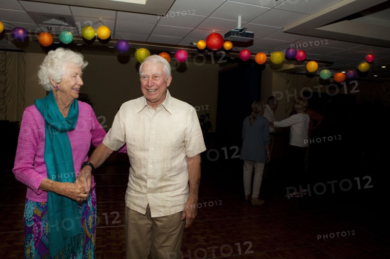 Older Caucasian couple dancing at party in retirement home
