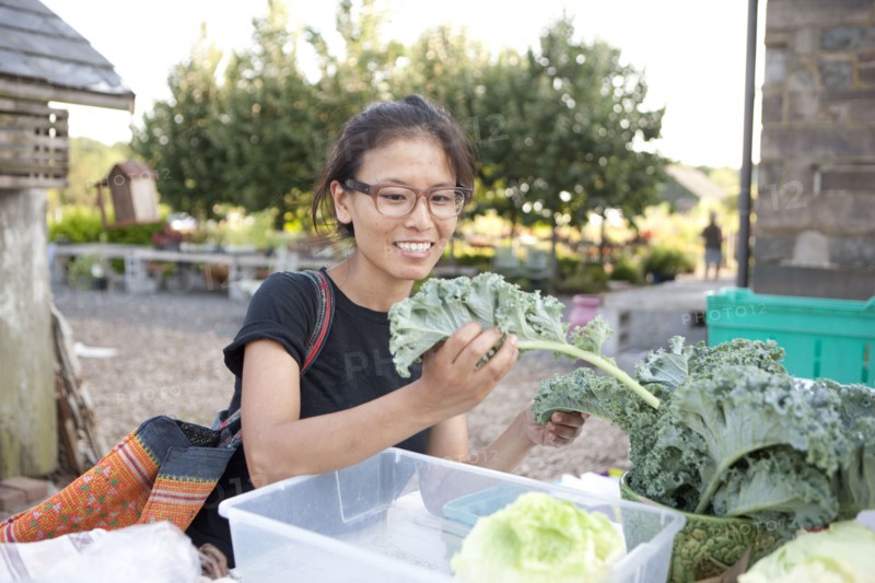 Woman shopping for greens at farmers market
