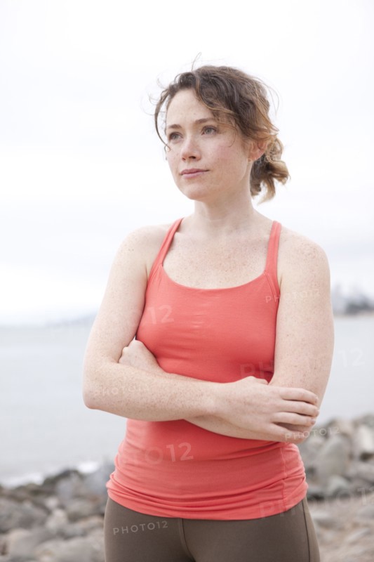 Caucasian woman standing on rocky beach