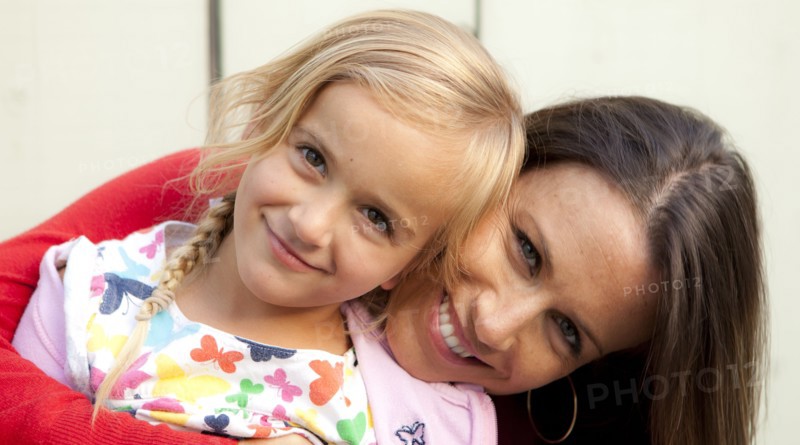 Caucasian mother and daughter smiling outdoors