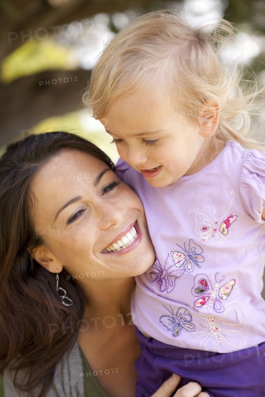 Caucasian mother and daughter smiling outdoors
