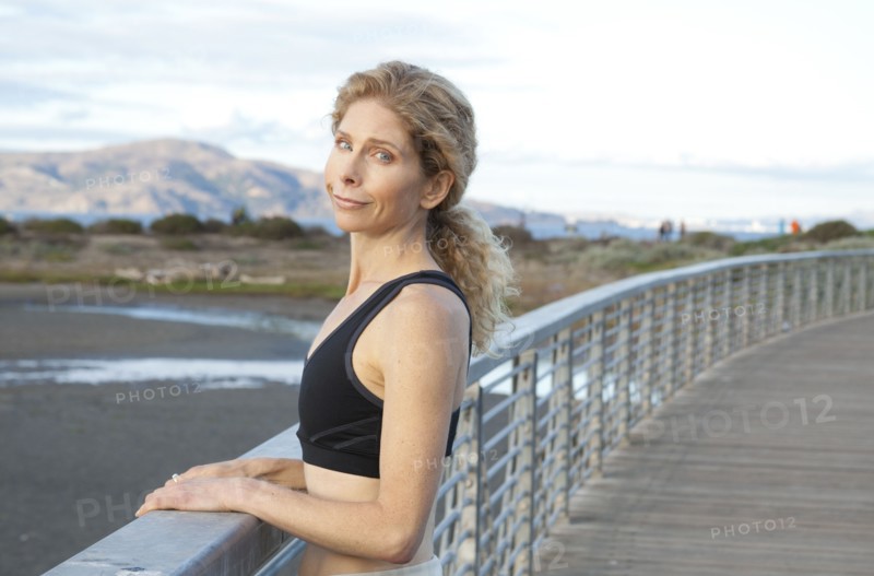 Caucasian woman standing on footbridge