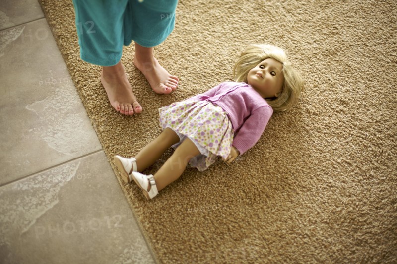 High angle view of teenage girl standing over doll