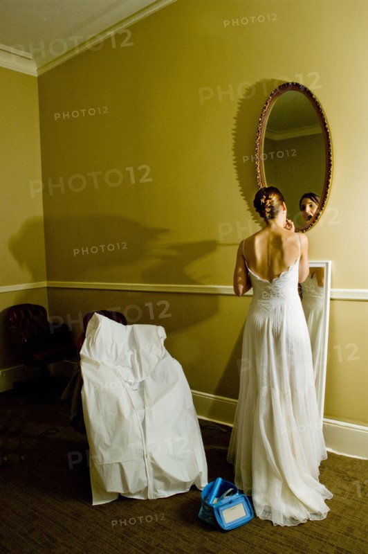 Bride adjusting makeup in mirror