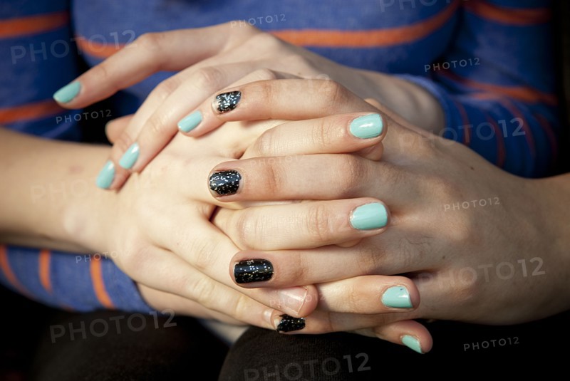 Close up of women holding hands