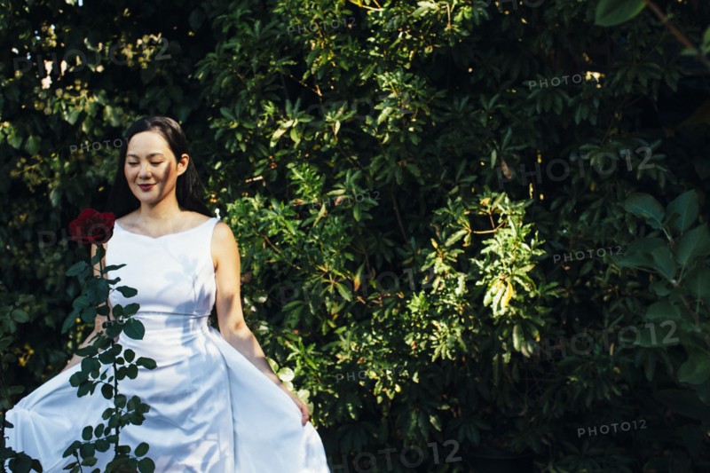 Korean bride wearing wedding dress in garden