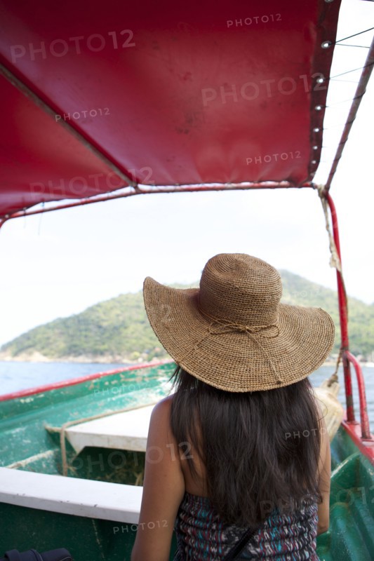 Woman wearing sun hat on ferry boat