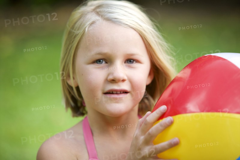 Close up of girl holding beach ball