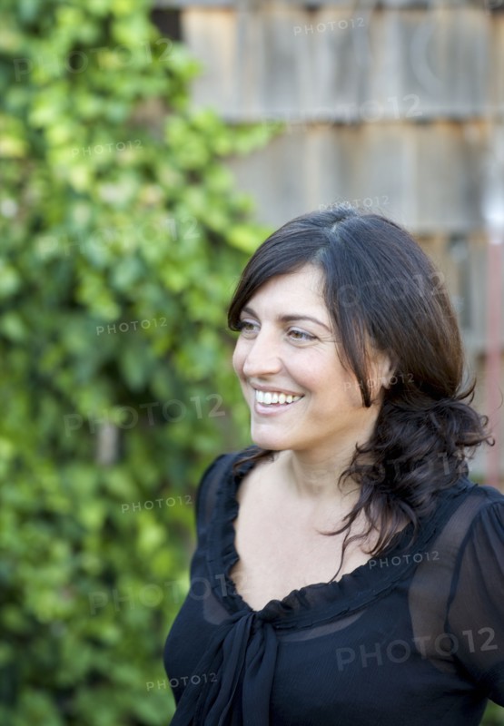 Close up of smiling woman in backyard