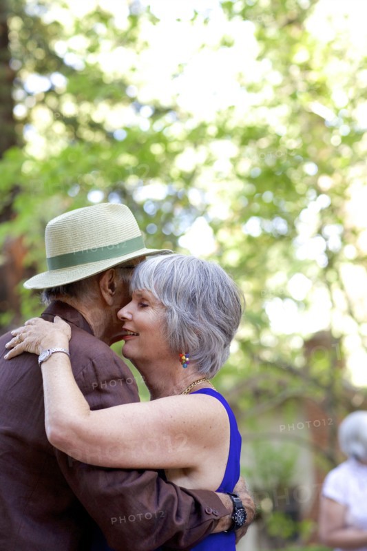 Older couple dancing in backyard