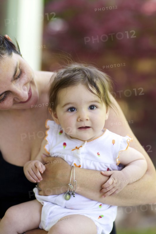 Close up of mother holding baby daughter