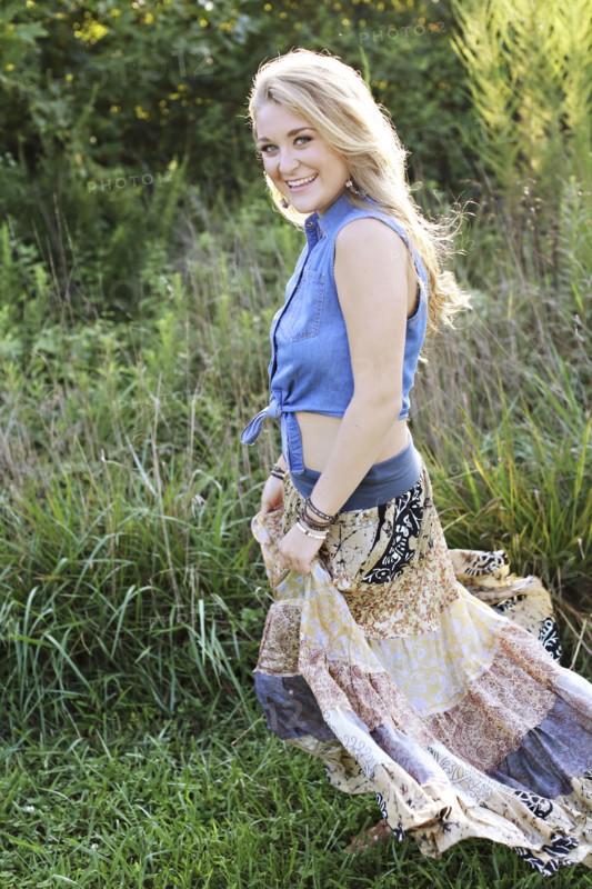 Teenage girl walking in tall grass