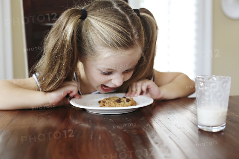 Girl shouting at cookie on table