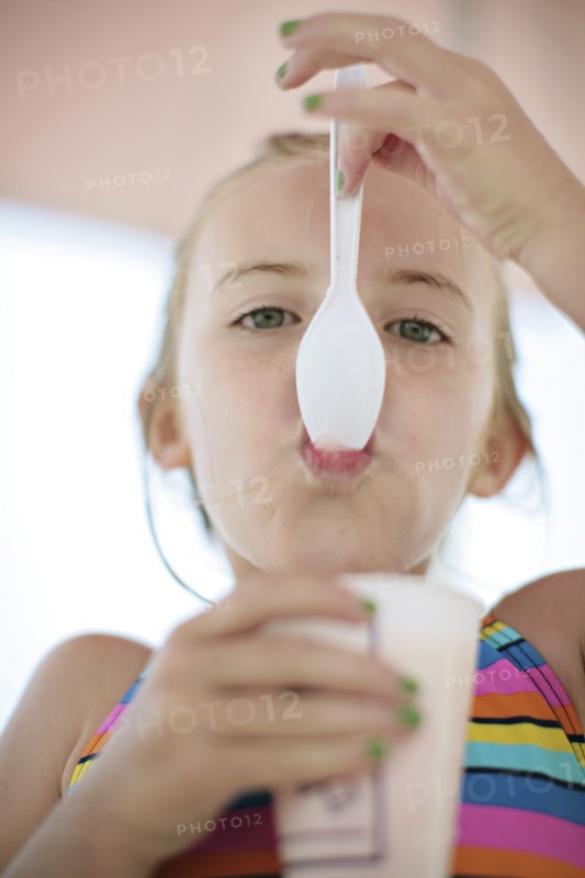 Close up of Caucasian girl eating ice cream