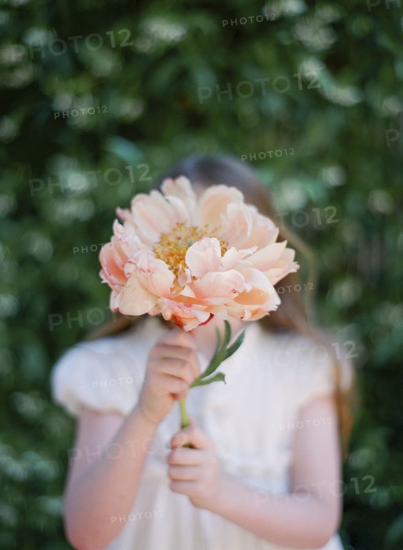 Close up of girl holding bouquet of flowers