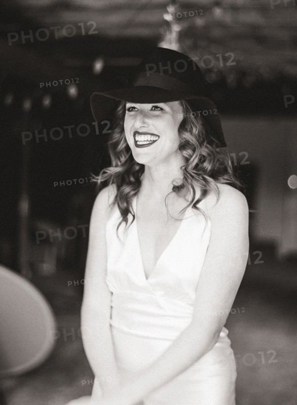 Smiling woman wearing sun hat in backyard
