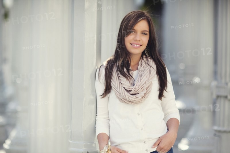 Smiling woman leaning on columns