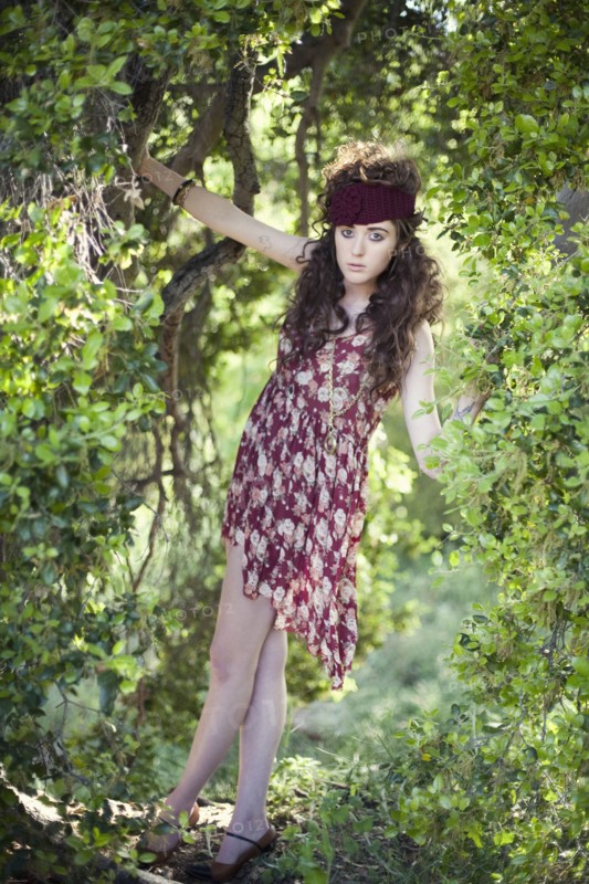 Woman in vintage dress climbing tree