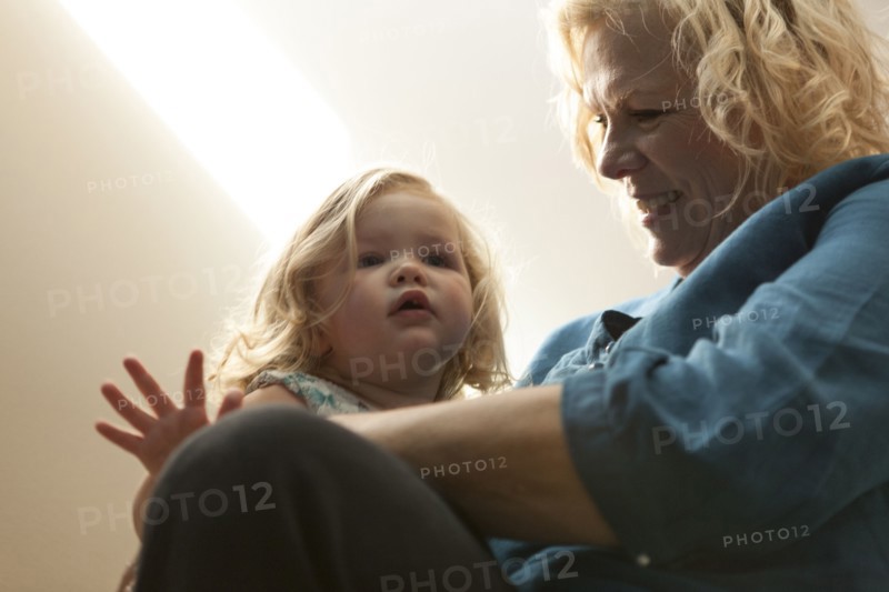 Close up of grandmother holding granddaughter
