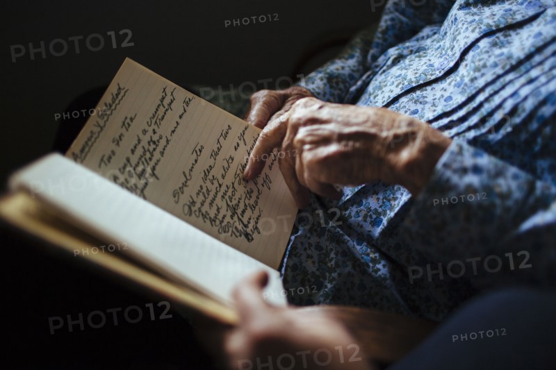 Older woman reading handwriting to granddaughter