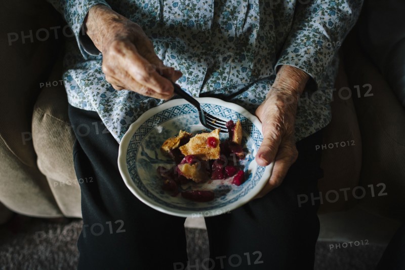 Close up of older mixed race woman eating