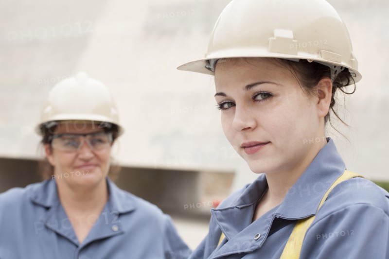 Workers wearing hard-hats and uniforms at work