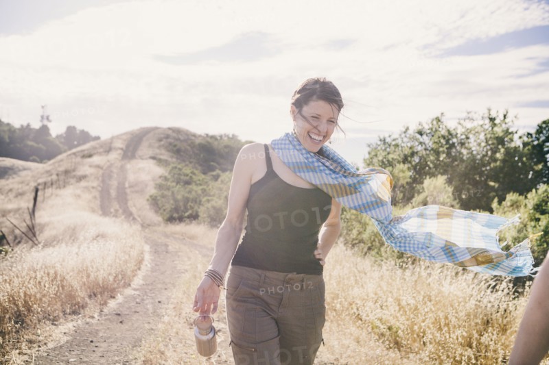 Caucasian woman walking on rural dirt road