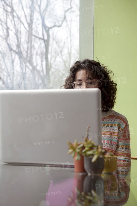 Caucasian businesswoman using laptop at desk