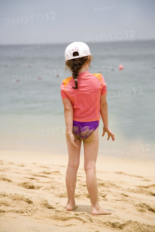 Caucasian girl walking on beach