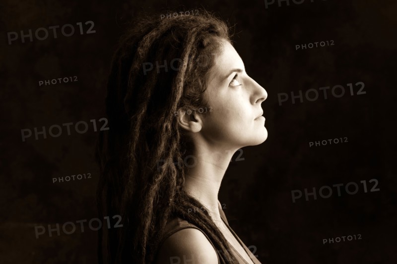 Close up profile of serious woman with dreadlocks