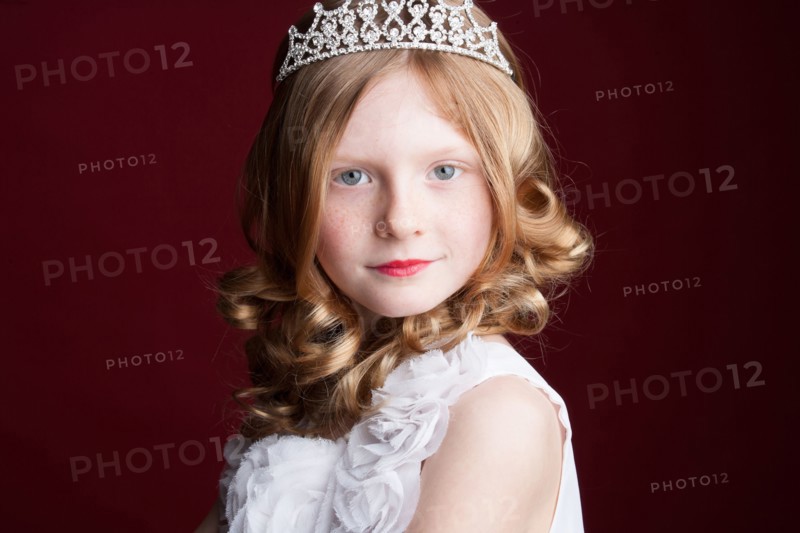 Caucasian girl wearing tiara and princess costume