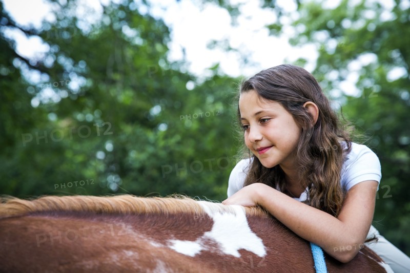 Close up of teenage girl riding horse