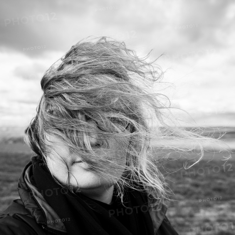 Caucasian woman with hair blowing in wind