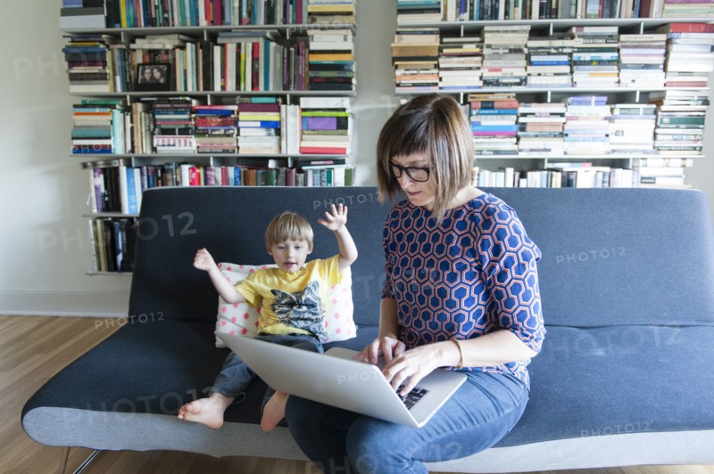 Mother and son using laptop