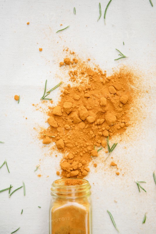 Jar of spilled spices and herbs