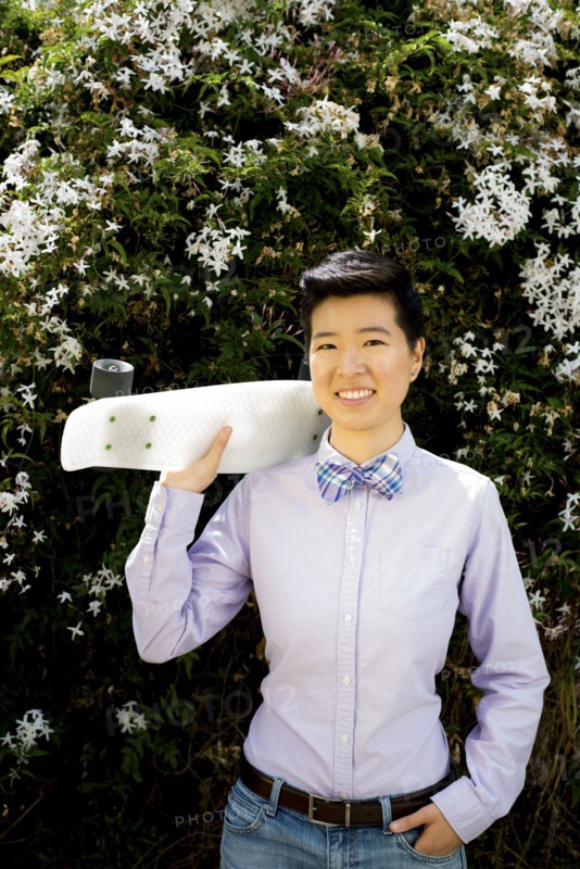 Androgynous woman holding skateboard